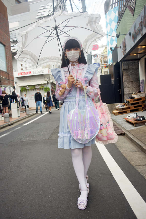 Trendy Harajuku Fashionistas Posing In Tokyo Wallpaper