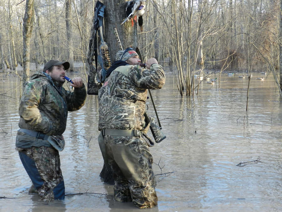 Two Men Standing In A Flooded Area Wallpaper