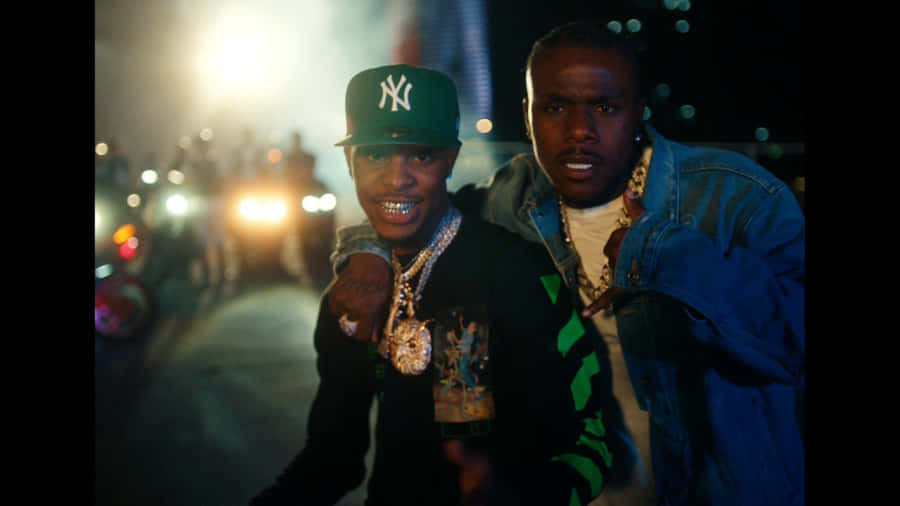 Two Men Standing Next To Each Other At Night Wallpaper