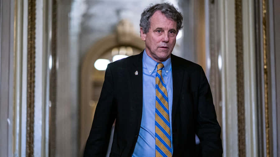 U.s. Senator Sherrod Brown Walking Through The Capitol Wallpaper
