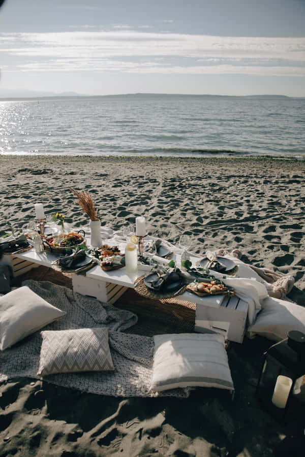 Unwind At The Perfect Beach Picnic Wallpaper