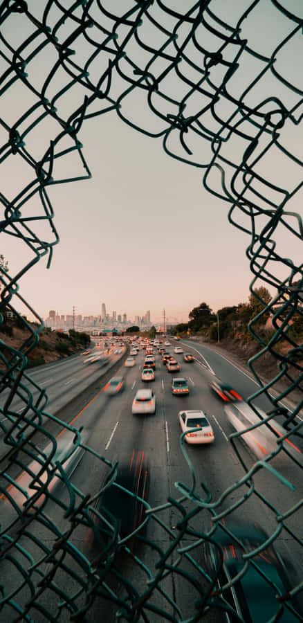 Urban Traffic Through Fence Wallpaper