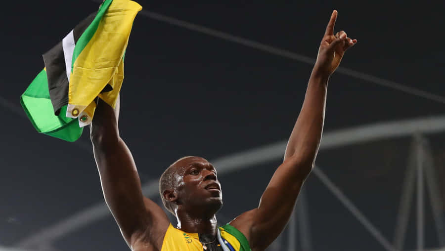 Usain Bolt Triumphantly Cheering With Jamaican Flag Wallpaper