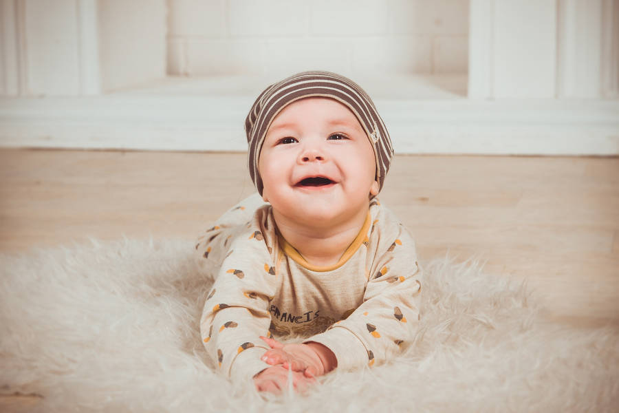 Very Cute Baby On Fluffy Rug Wallpaper