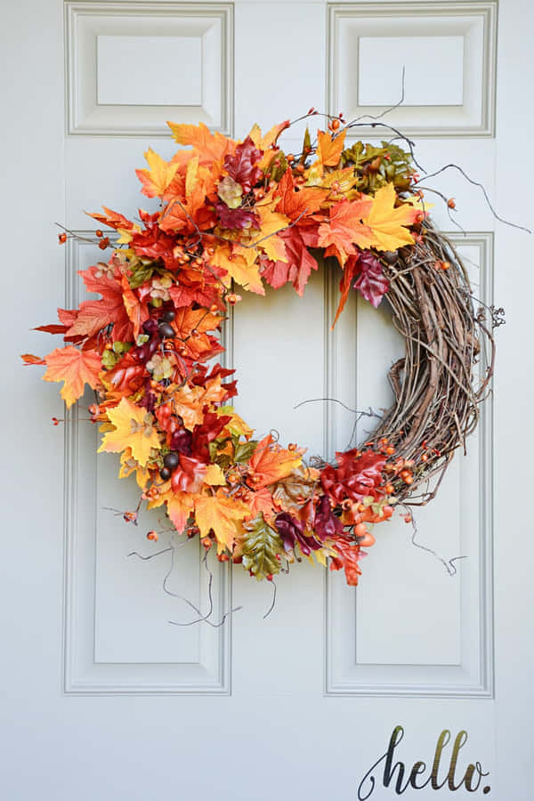 Vibrant Fall Wreath On Rustic Wooden Door Wallpaper
