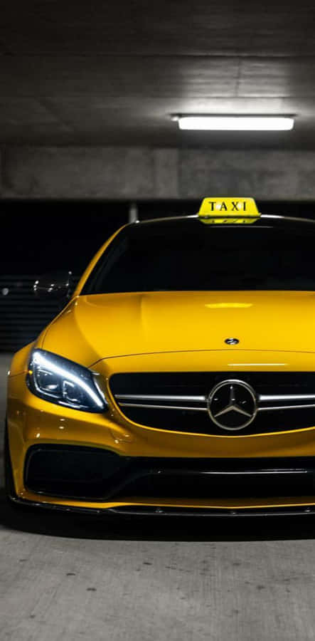 Vibrant Yellow Cab In The City Wallpaper
