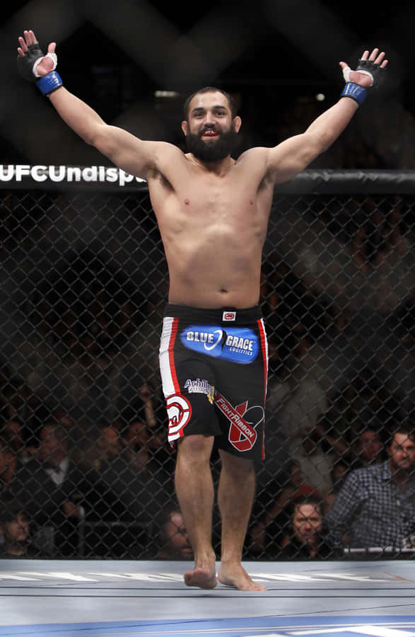 Victorious Moment – Johny Hendricks Celebrating His Win In The Octagon Wallpaper