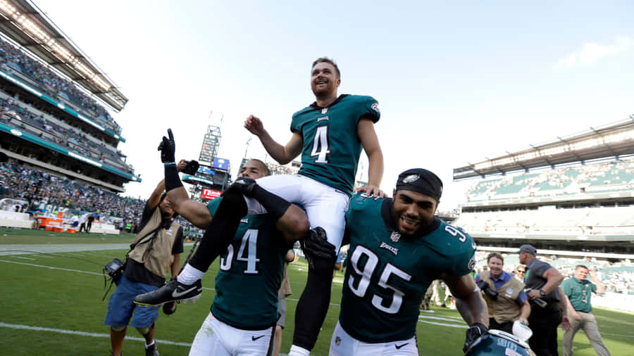 Victorious Shoulder Ride Football Player Wallpaper