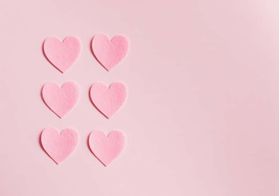 View Of A Majestic Lake Surrounded By Lush Green Vegetation. Wallpaper