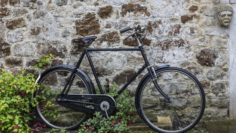 Vintage Bicycle Against Stone Wall Wallpaper