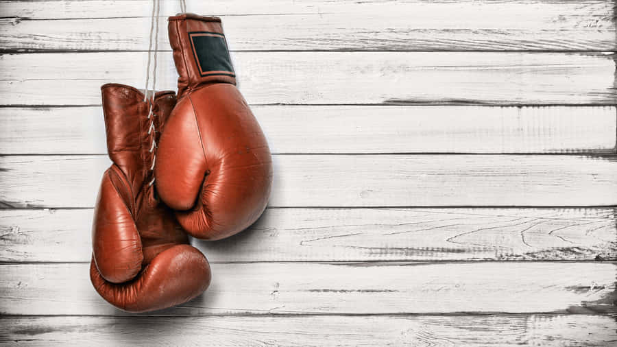 Vintage Boxing Gloveson Wooden Background Wallpaper