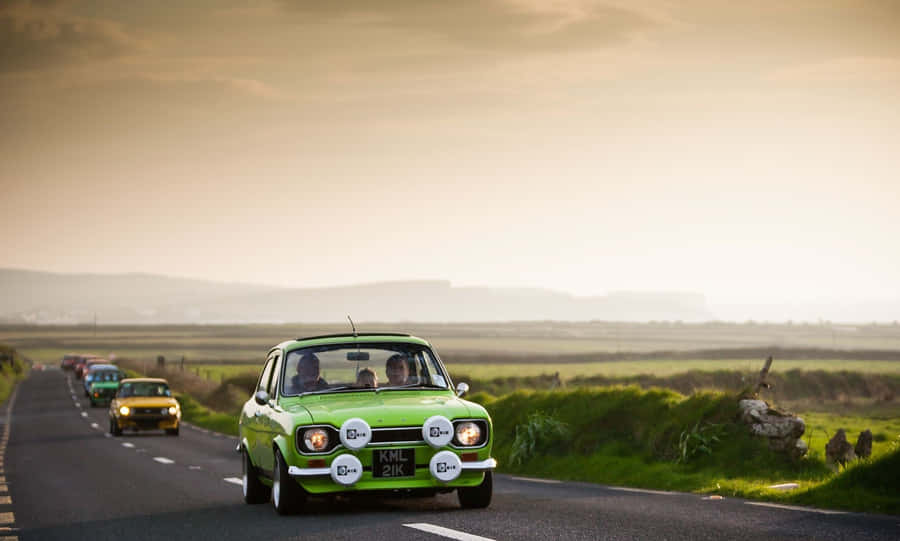Vintage Ford Escort Cruising Down The Highway Wallpaper
