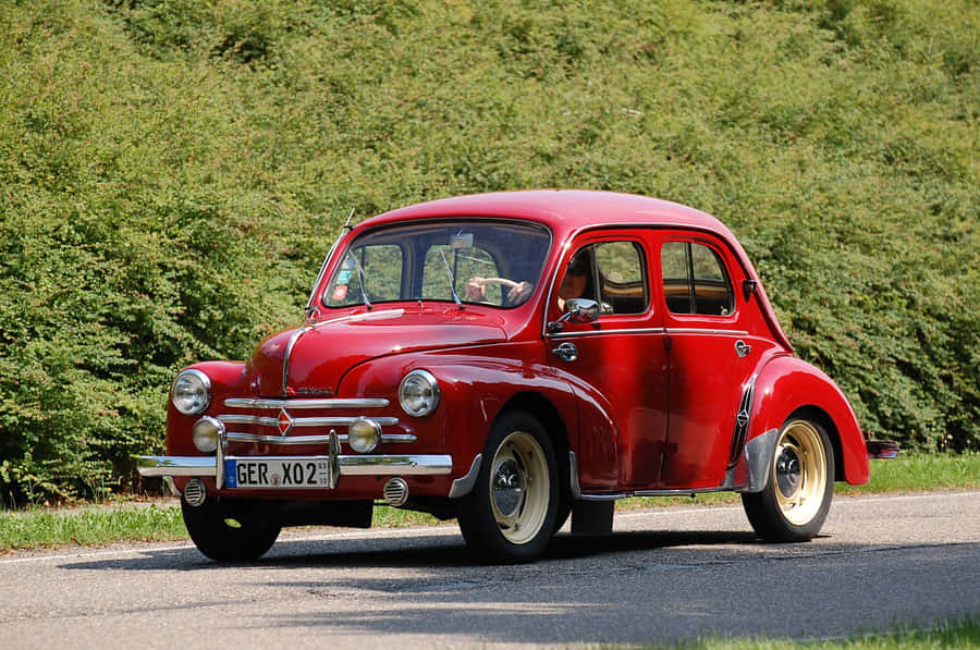 Vintage Red Car Countryside Drive Wallpaper