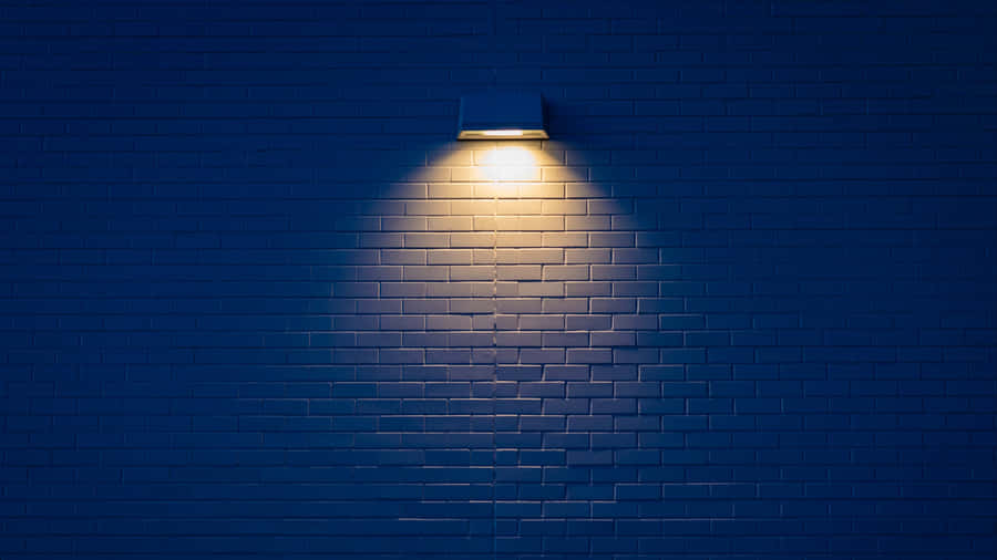 Wall Mounted Lamp Illuminating Bricks Wallpaper