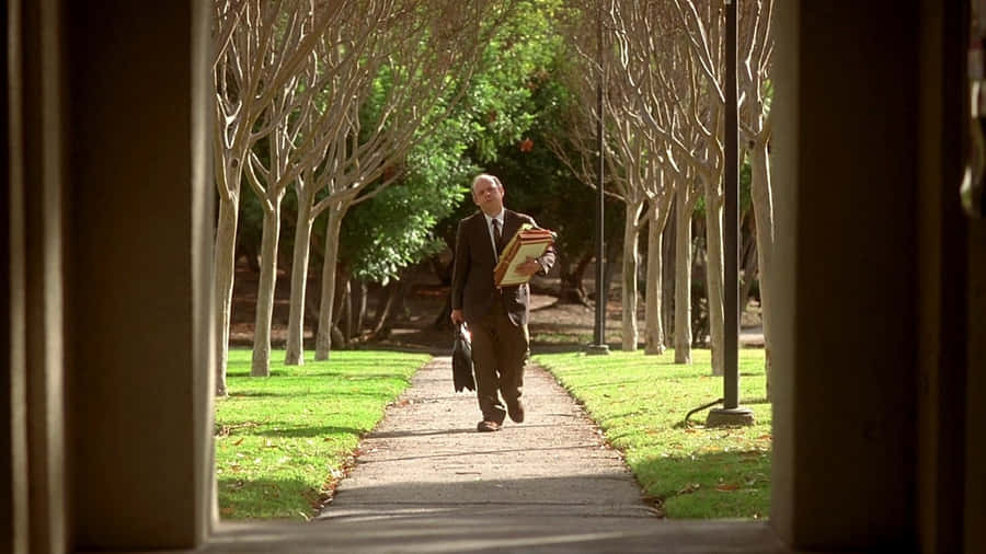 Wallace Shawn Relaxing In A Chair Wallpaper