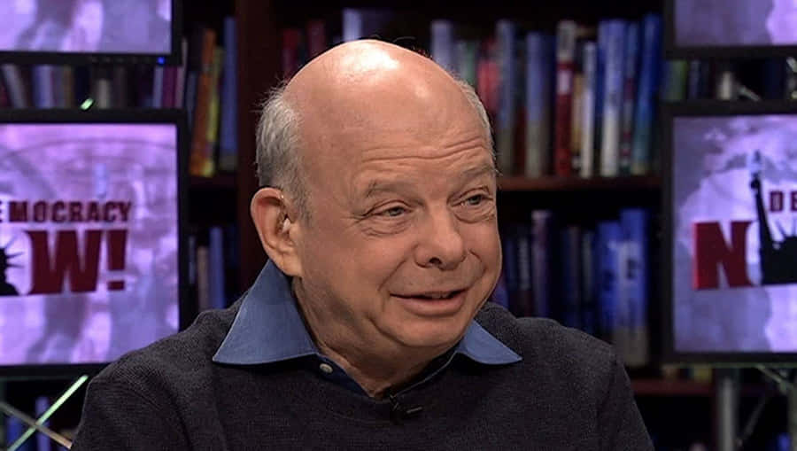 Wallace Shawn Smiling In A Studio Wallpaper