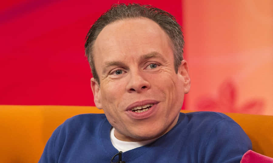 Warwick Davis Posing For A Portrait Wallpaper