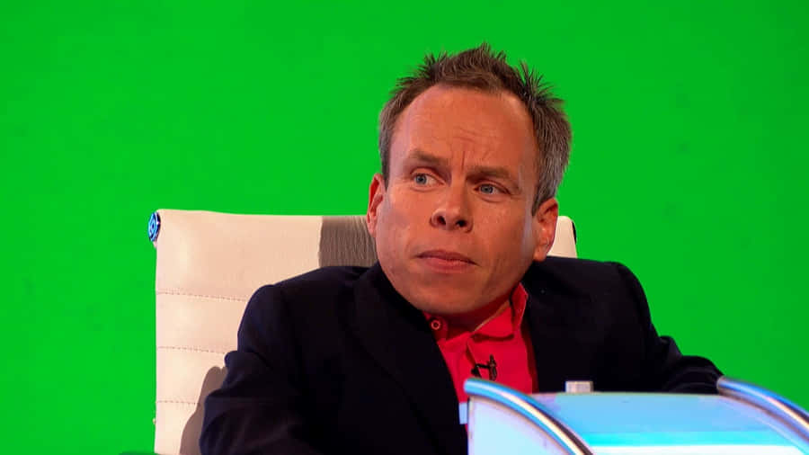 Warwick Davis Posing With His Hands Folded Wallpaper