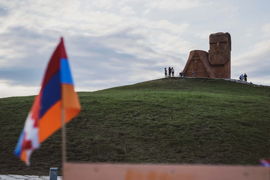 We Are Our Mountains Monument With Flag Wallpaper