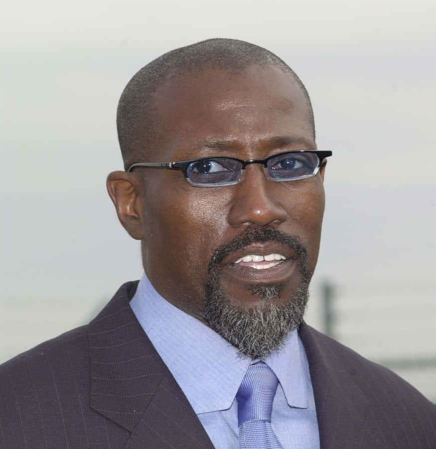 Wesley Snipes Striking A Pose In A Sharp Suit Wallpaper