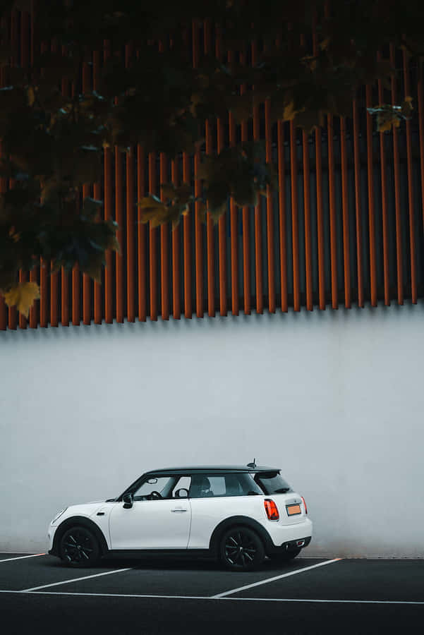 White Mini Cooper Parked Beside Modern Wall Wallpaper