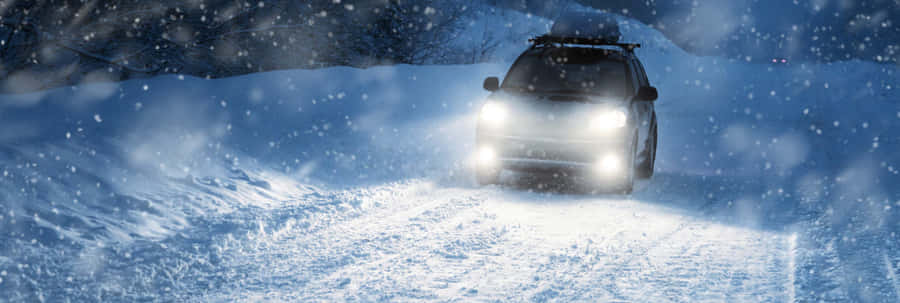 Winter Driving In Snowy Mountain Road Wallpaper