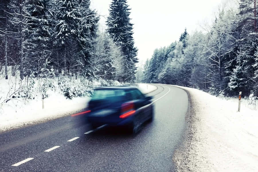Winter Driving On A Snowy Road Wallpaper