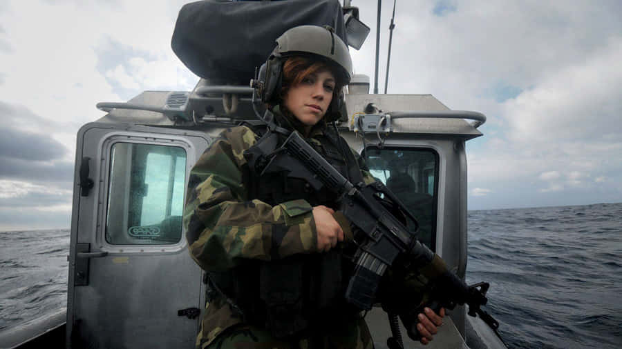 Woman Holding Gun Uniform On Boat Wallpaper