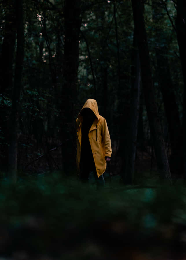 Woman In A Bright Yellow Raincoat On A Rainy Day Wallpaper