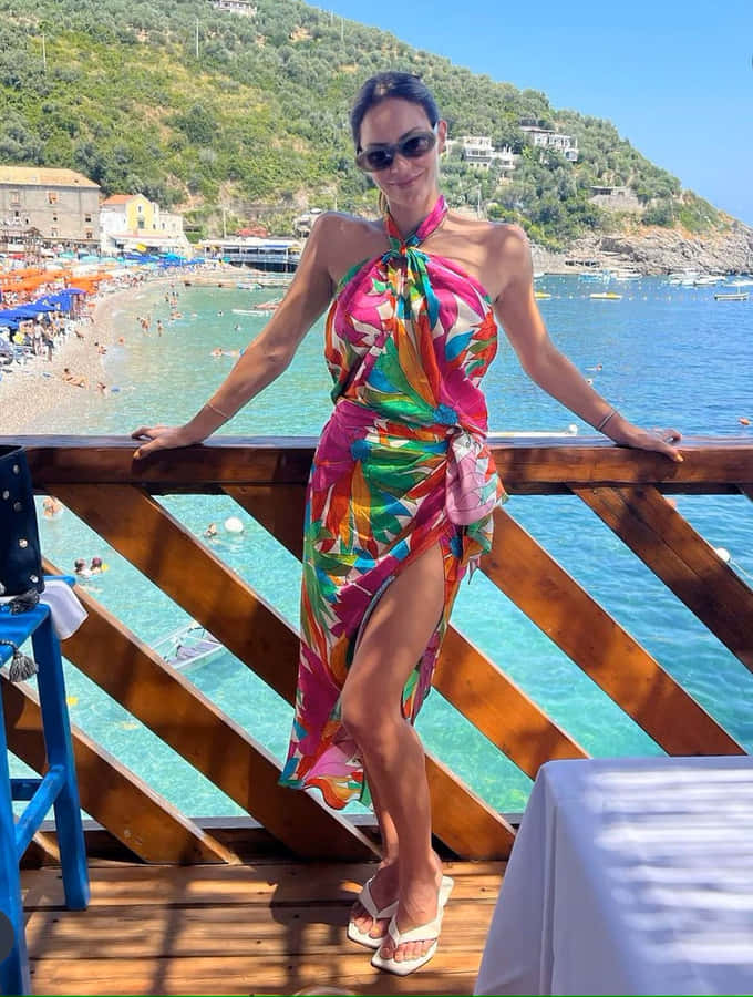 Womanin Colorful Dressat Beachside Wallpaper