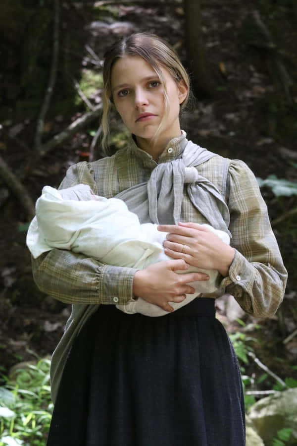 Womanin Historical Costume Holding Baby Wallpaper