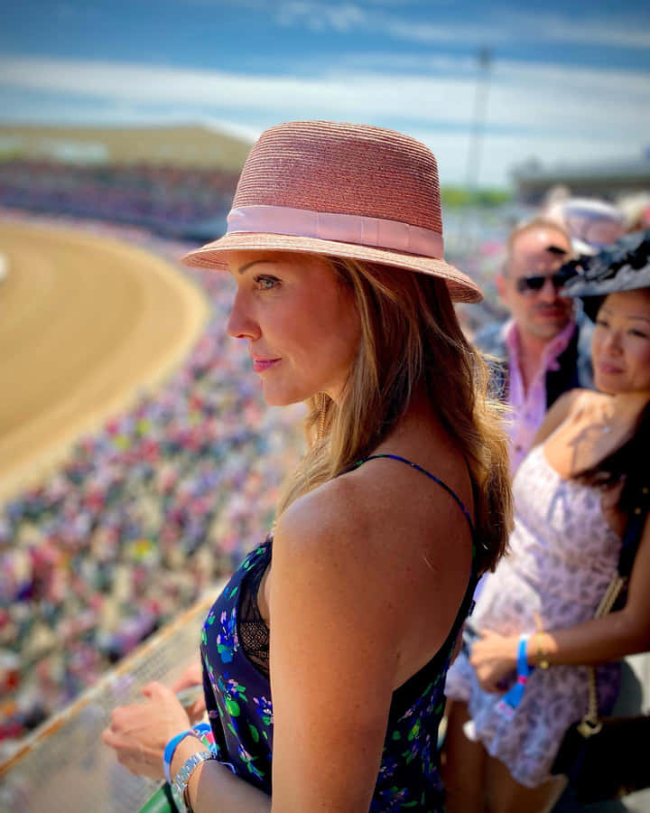 Womanin Pink Hatat Sporting Event Wallpaper