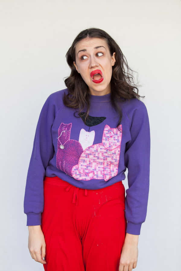 Womanin Purple Sweater Red Pants Making Face Wallpaper