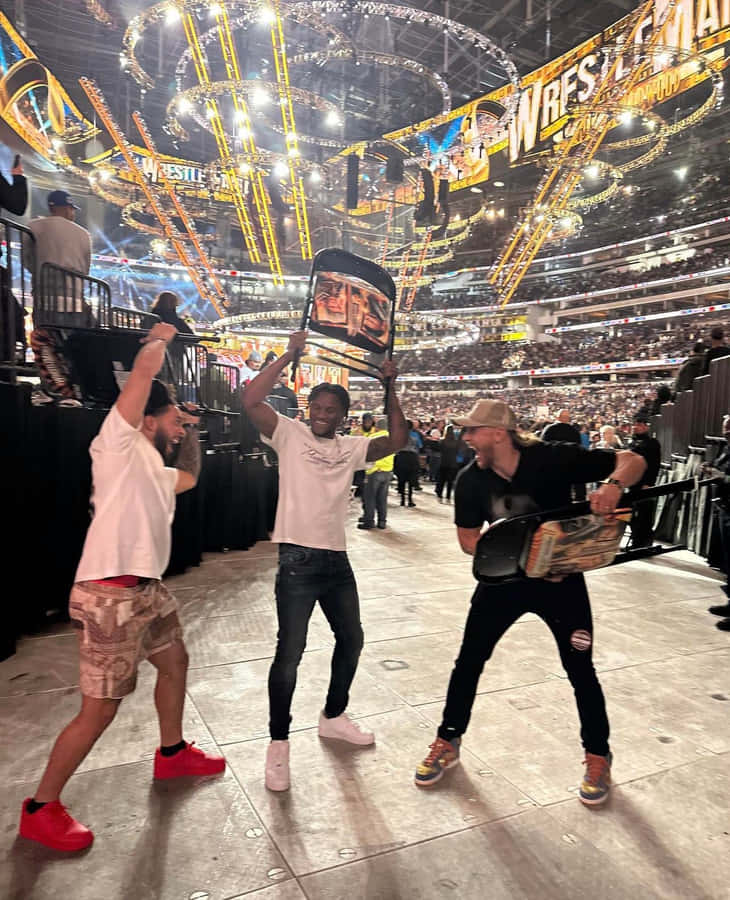 Wrestle Mania Fans With Championship Belts Wallpaper