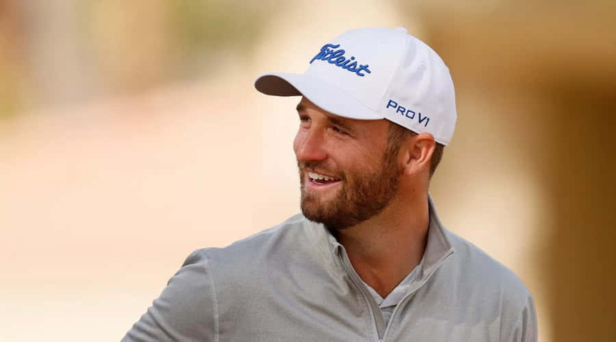 Wyndham Clark Swinging The Club At A Lush Green Golf Course Wallpaper