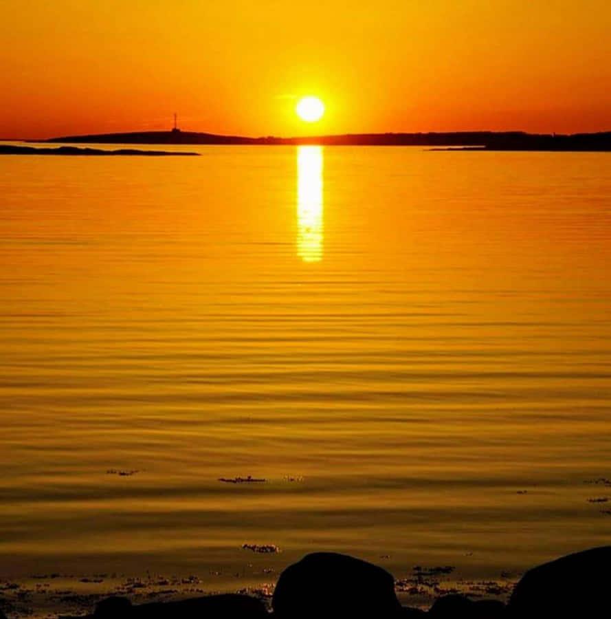 Yellow Sunset Over Tranquil Waters Wallpaper