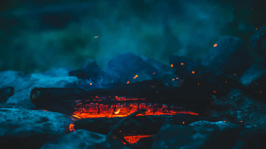 Young Couple Hiking Under A Vibrant Red Sunset Wallpaper