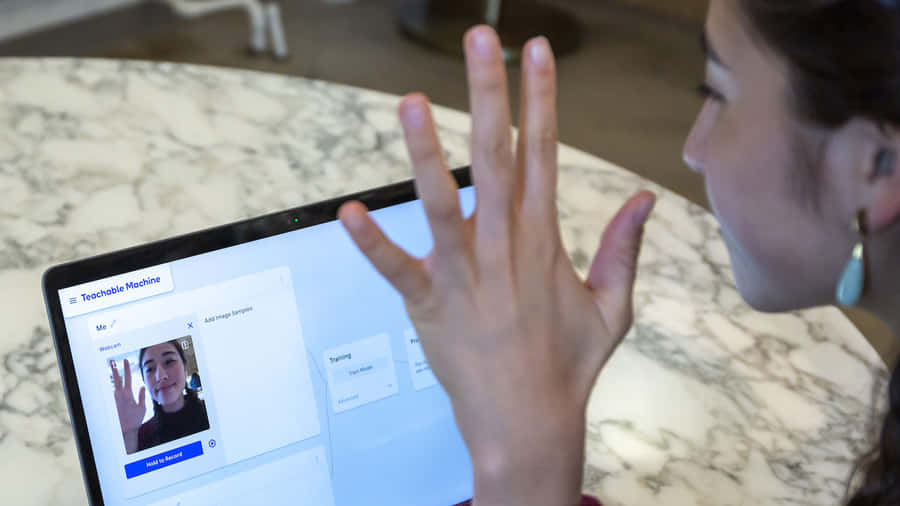 Young Girl Interacting With Teachable Machine Wallpaper