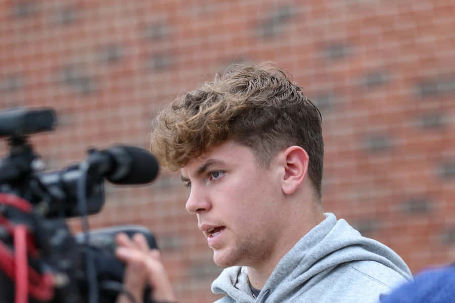 Young Man Interview Outdoors Wallpaper