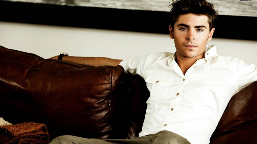 Zac Efron Reclining In Comfort Wallpaper