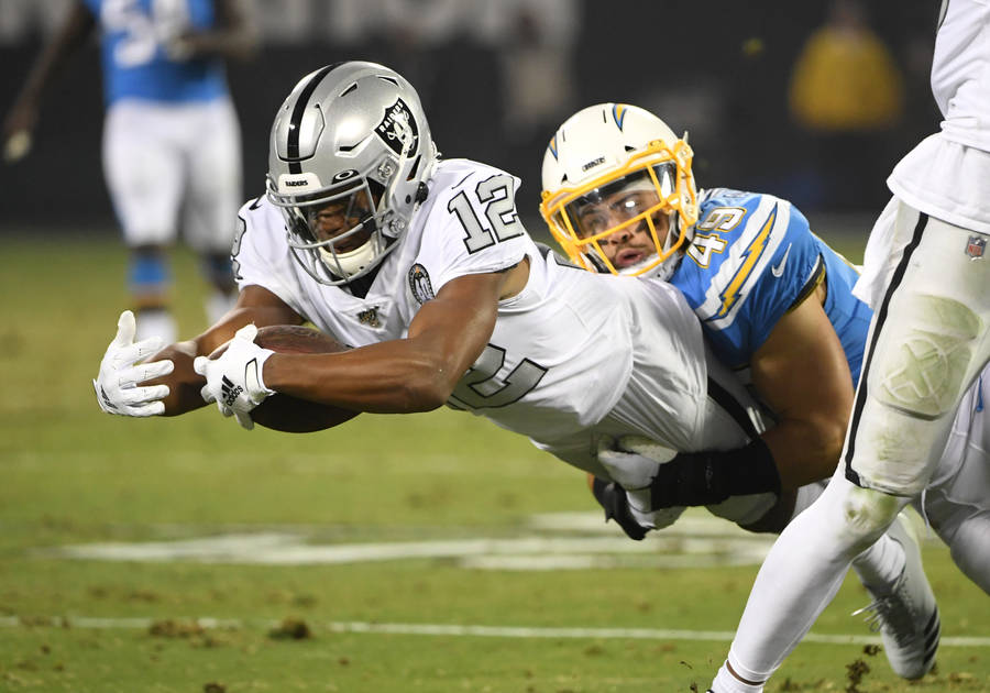 Zay Jones Tackled By Opposing Player Wallpaper