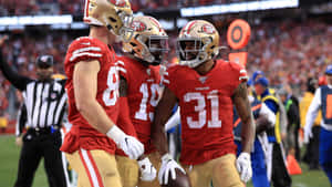 49ers Players Celebratingon Field Wallpaper