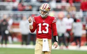 49ers Quarterback Brock Purdy Signaling On Field.jpg Wallpaper