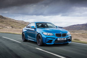 4k Bmw Blue Car In Highway Wallpaper