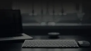 4k Laptop On Gloomy Desk Wallpaper