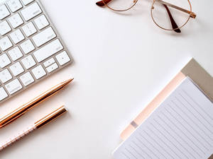 4k White Clean Desk With Rose Gold Accessories Wallpaper