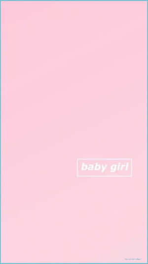 A Baby Girl Dressed In Pink Showing Off Her Sweet Smile. Wallpaper