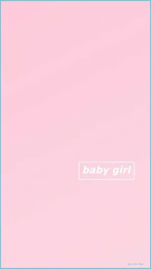 A Baby Girl Dressed In Pink Showing Off Her Sweet Smile. Wallpaper