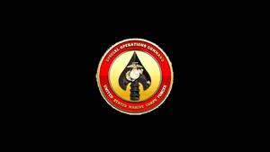 A Badge With A Red And Yellow Emblem On It Wallpaper