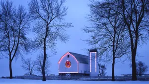 A Barn With A Christmas Tree In The Snow Wallpaper